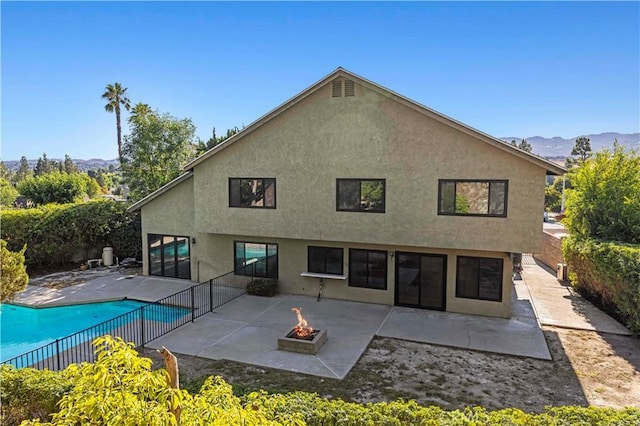 22526 Napa St, West Hills, CA 91304 - back of house featuring a fire pit, a patio area, stucco siding, and a mountain view