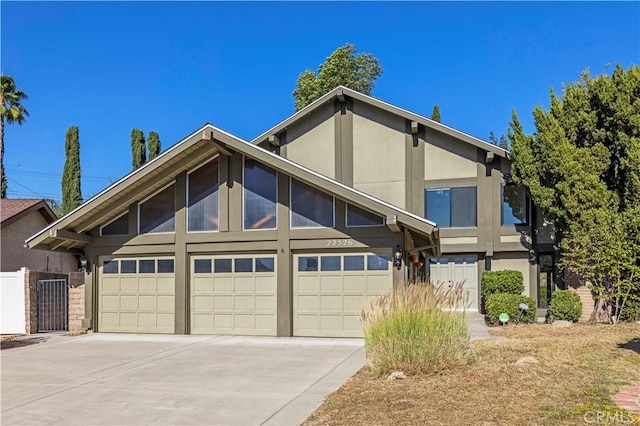 22526 Napa St, West Hills, CA 91304 - view of front facade featuring driveway, an attached garage, and stucco siding