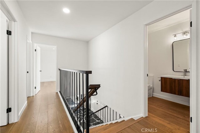 22526 Napa St, West Hills, CA 91304 - hallway featuring an upstairs landing, wood finished floors, and recessed lighting
