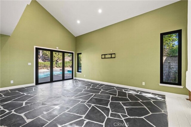 22526 Napa St, West Hills, CA 91304 - unfurnished room with stone flooring, high vaulted ceiling, and recessed lighting