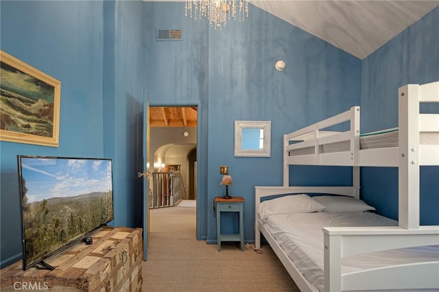 969 Oak Dr, Crestline, CA 92325 - carpeted bedroom featuring high vaulted ceiling, arched walkways, and a chandelier