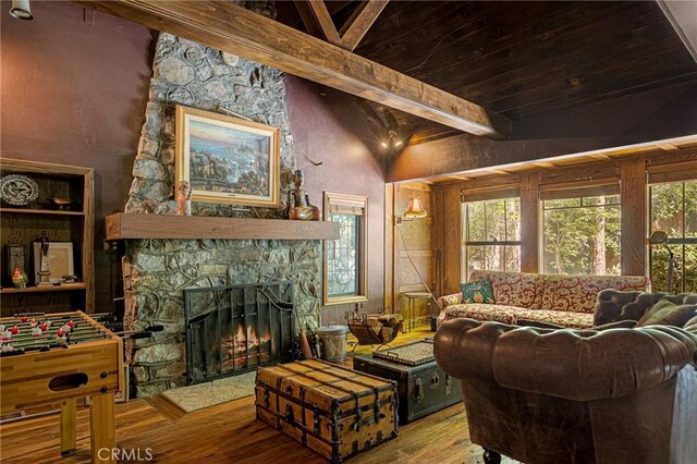 969 Oak Dr, Crestline, CA 92325 - living room featuring wood finished floors, a fireplace, a wood ceiling with exposed beams, and healthy amount of natural light