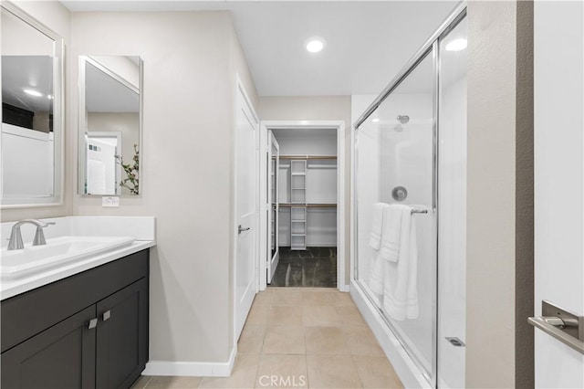 107 Bowery, Irvine, CA 92612 - full bath featuring a spacious closet, vanity, a shower stall, tile patterned flooring, and recessed lighting