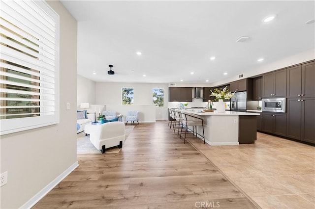 107 Bowery, Irvine, CA 92612 - kitchen featuring appliances with stainless steel finishes, a kitchen island, recessed lighting, light countertops, and light wood-style flooring