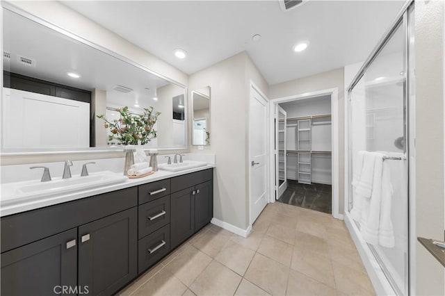 107 Bowery, Irvine, CA 92612 - bathroom with double vanity, a spacious closet, a stall shower, tile patterned floors, and recessed lighting