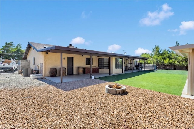 7505 Jenkins Ave, Hesperia, CA 92345 - rear view of house with a patio area, stucco siding, an outdoor fire pit, and a fenced backyard
