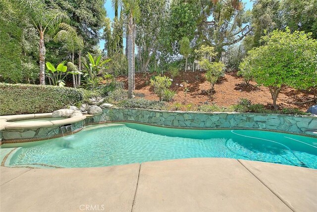 3039 Olympic View Dr, Chino Hills, CA 91709 - view of swimming pool with a pool with connected hot tub and view of wooded area