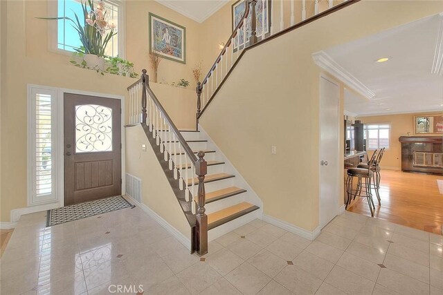 3039 Olympic View Dr, Chino Hills, CA 91709 - entrance foyer with tile patterned floors, crown molding, stairway, a high ceiling, and recessed lighting