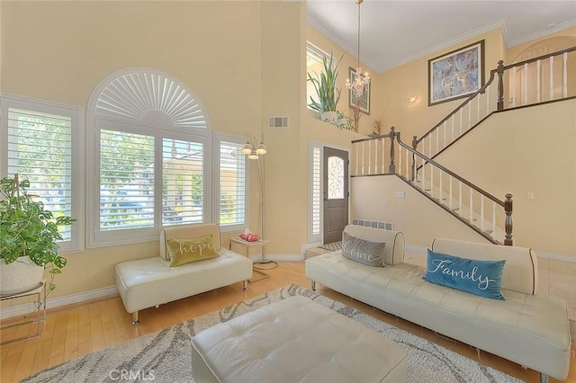 3039 Olympic View Dr, Chino Hills, CA 91709 - living area featuring wood finished floors, crown molding, a towering ceiling, and stairs
