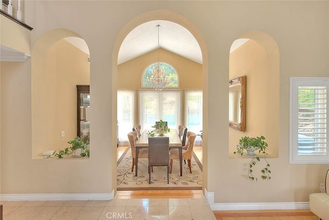 3039 Olympic View Dr, Chino Hills, CA 91709 - dining area featuring vaulted ceiling, a chandelier, tile patterned floors, and arched walkways