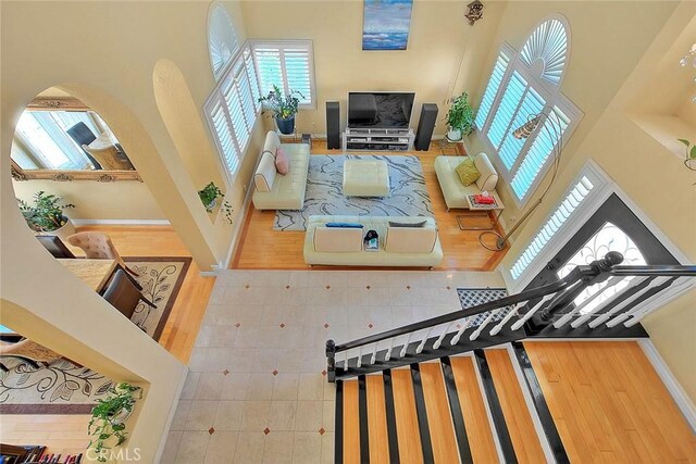 3039 Olympic View Dr, Chino Hills, CA 91709 - living area with a towering ceiling, wood finished floors, and arched walkways