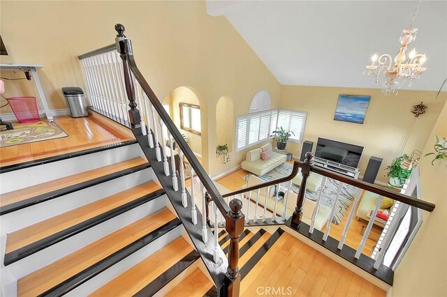 3039 Olympic View Dr, Chino Hills, CA 91709 - stairway with hardwood / wood-style flooring, a chandelier, and high vaulted ceiling