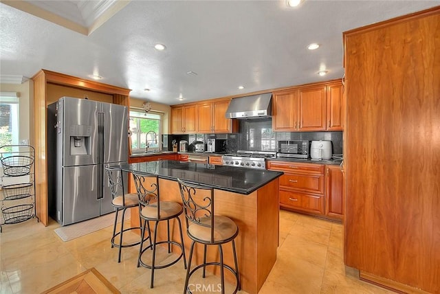 3039 Olympic View Dr, Chino Hills, CA 91709 - kitchen featuring stainless steel appliances, wall chimney range hood, a kitchen breakfast bar, tasteful backsplash, and recessed lighting