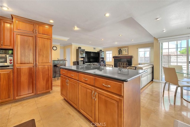 3039 Olympic View Dr, Chino Hills, CA 91709 - kitchen with dark countertops, ornamental molding, brown cabinetry, open floor plan, and a center island