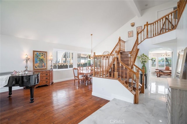 2741 Olympic View Dr, Chino Hills, CA 91709 - living area with a chandelier, high vaulted ceiling, stairs, beamed ceiling, and arched walkways