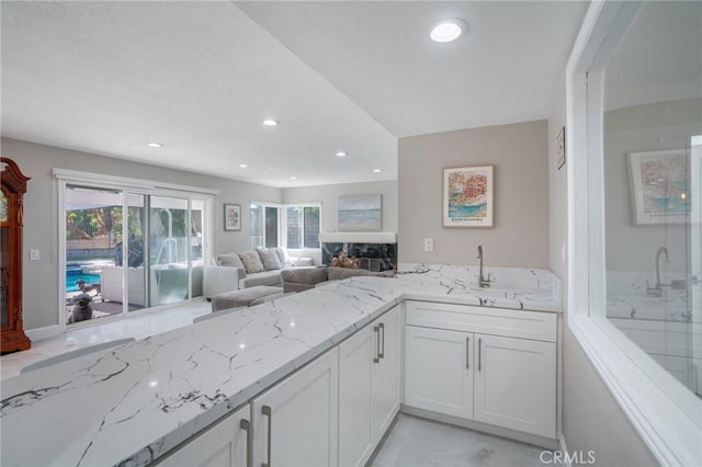 2741 Olympic View Dr, Chino Hills, CA 91709 - kitchen with light stone counters, recessed lighting, white cabinetry, and open floor plan
