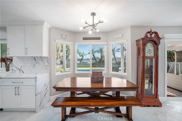 2741 Olympic View Dr, Chino Hills, CA 91709 - dining space with a chandelier, healthy amount of natural light, light marble finish floors, and a textured ceiling