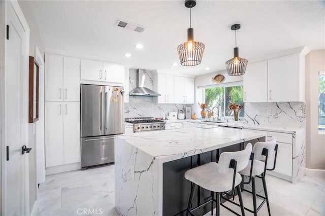 2741 Olympic View Dr, Chino Hills, CA 91709 - kitchen with wall chimney exhaust hood, freestanding refrigerator, backsplash, light marble finish flooring, and recessed lighting