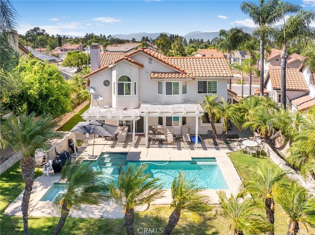 2741 Olympic View Dr, Chino Hills, CA 91709 - back of property featuring a pergola, a tiled roof, a chimney, a fenced backyard, and stucco siding