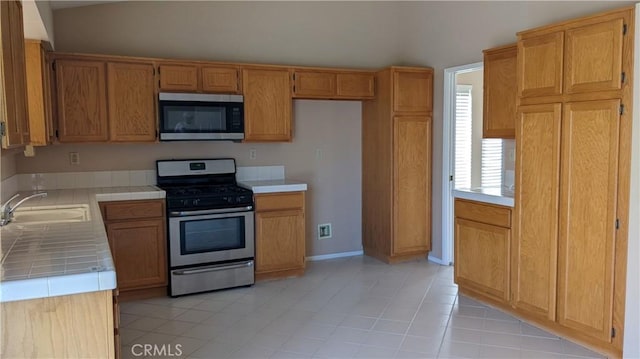 27297 Terrytown Rd, Menifee, CA 92586 - kitchen featuring appliances with stainless steel finishes, tile countertops, and light tile patterned floors