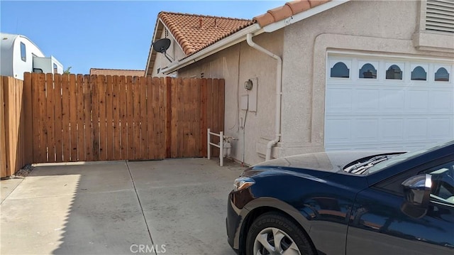 27297 Terrytown Rd, Menifee, CA 92586 - view of side of home with stucco siding, an attached garage, and a tile roof