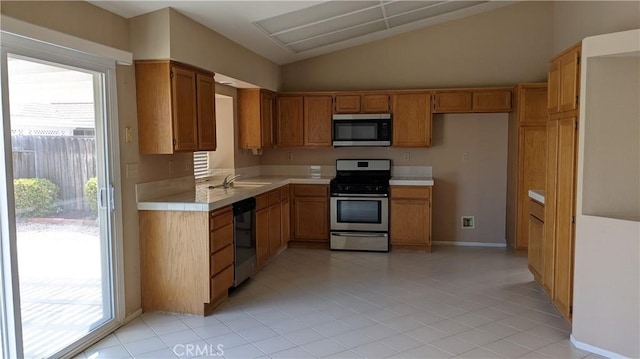 27297 Terrytown Rd, Menifee, CA 92586 - kitchen featuring stainless steel appliances, vaulted ceiling, plenty of natural light, and brown cabinets