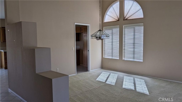 27297 Terrytown Rd, Menifee, CA 92586 - carpeted spare room with a chandelier and a towering ceiling