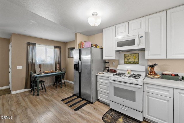 2540 El Dorado Ave Unit A, Oxnard, CA 93033 - kitchen with white appliances, light wood-type flooring, light countertops, and white cabinetry