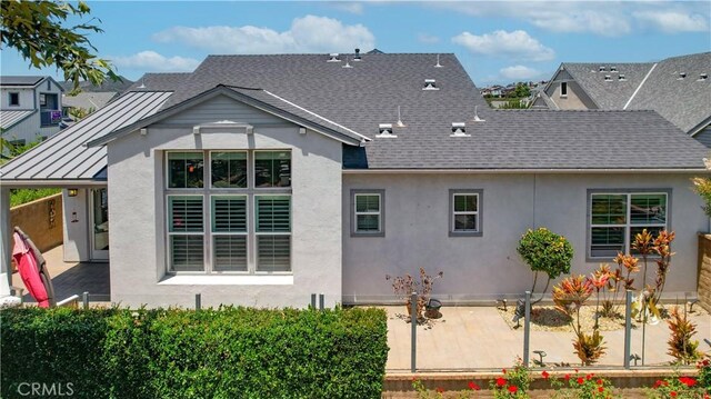 138 Listo St, Rancho Mission Viejo, CA 92694 - rear view of property with a patio area, a shingled roof, stucco siding, a standing seam roof, and a metal roof