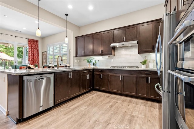 138 Listo St, Rancho Mission Viejo, CA 92694 - kitchen with appliances with stainless steel finishes, a peninsula, light wood-type flooring, dark brown cabinetry, and recessed lighting