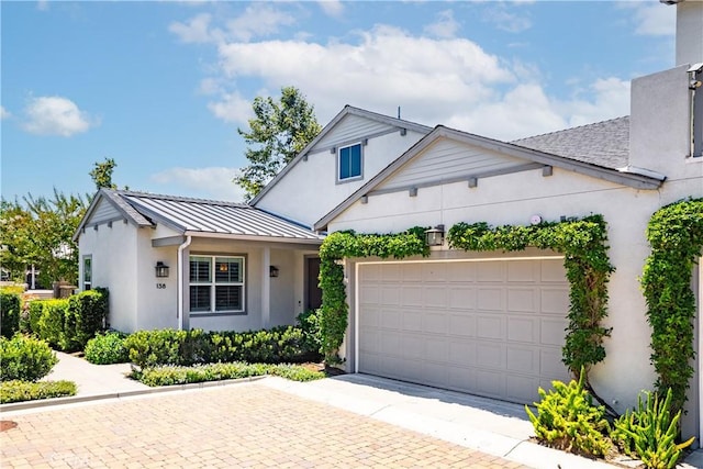 138 Listo St, Rancho Mission Viejo, CA 92694 - view of front of home with a standing seam roof, stucco siding, decorative driveway, a garage, and a metal roof