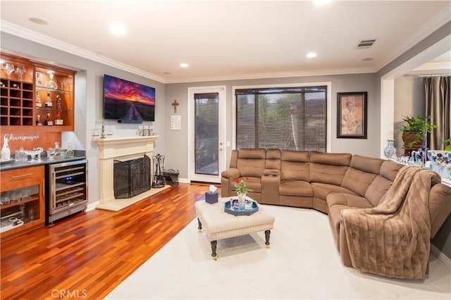 20642 Iris Canyon Rd, Riverside, CA 92508 - living area with wine cooler, wood finished floors, a dry bar, ornamental molding, and recessed lighting
