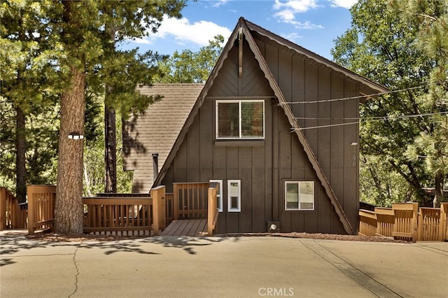 1296 Calgary Dr, Lake Arrowhead, CA 92352 - view of front of house featuring board and batten siding and a wooden deck