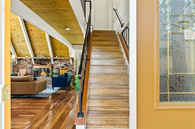 1296 Calgary Dr, Lake Arrowhead, CA 92352 - stairs with wood-type flooring, a fireplace, and a wood ceiling with exposed beams