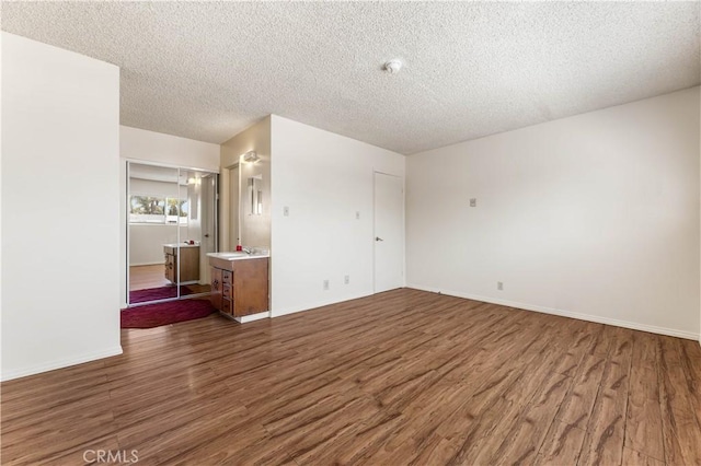 5530 Ackerfield Ave Unit 206, Long Beach, CA 90805 - spare room with wood finished floors and a textured ceiling
