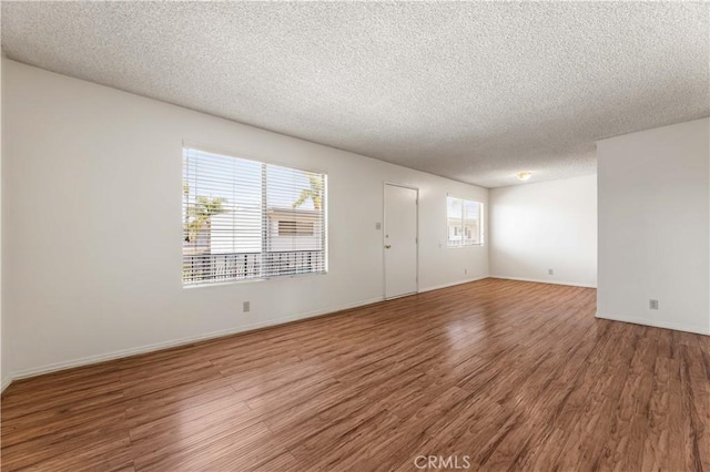 5530 Ackerfield Ave Unit 206, Long Beach, CA 90805 - unfurnished room featuring a textured ceiling and wood finished floors