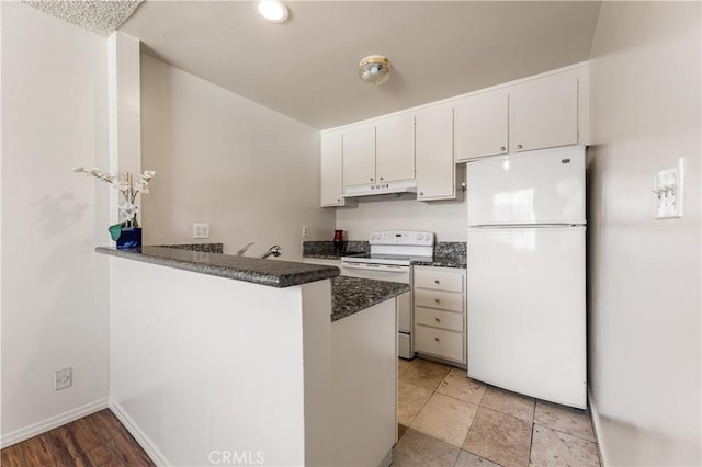 5530 Ackerfield Ave Unit 206, Long Beach, CA 90805 - kitchen with white appliances, under cabinet range hood, white cabinets, a peninsula, and recessed lighting