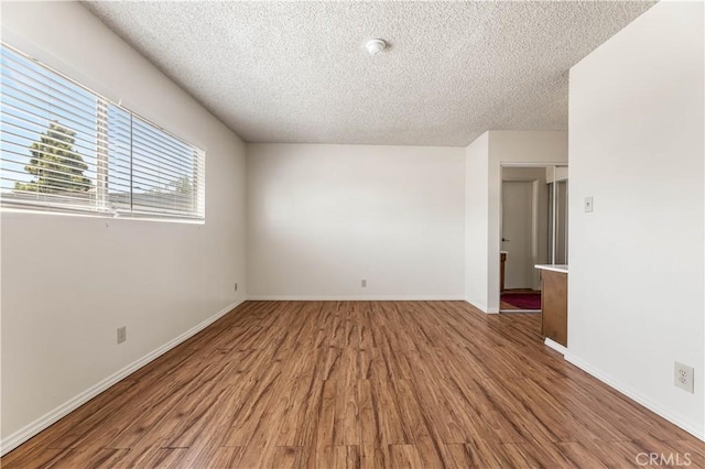 5530 Ackerfield Ave Unit 206, Long Beach, CA 90805 - empty room featuring a textured ceiling, light wood finished floors, and a smoke detector