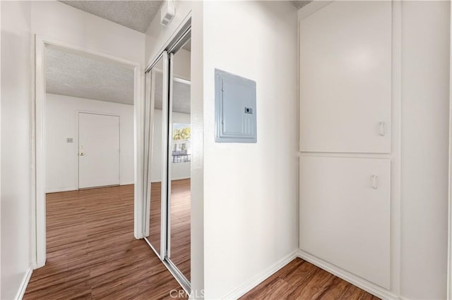 5530 Ackerfield Ave Unit 206, Long Beach, CA 90805 - hallway with electric panel, wood finished floors, and a textured ceiling