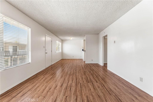 5530 Ackerfield Ave Unit 206, Long Beach, CA 90805 - spare room featuring a textured ceiling and light wood-style floors
