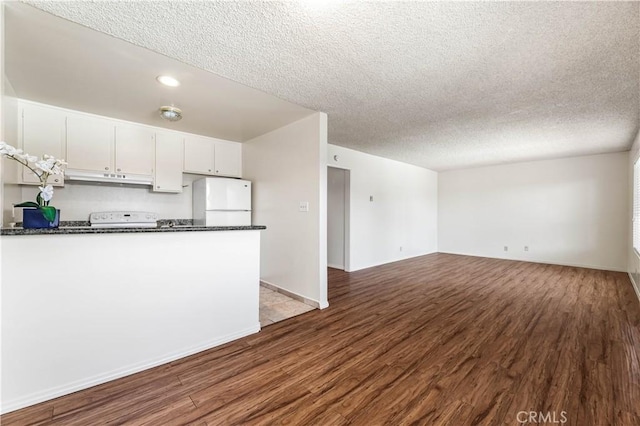 5530 Ackerfield Ave Unit 206, Long Beach, CA 90805 - kitchen with fridge, a textured ceiling, dark wood-style floors, under cabinet range hood, and white cabinetry