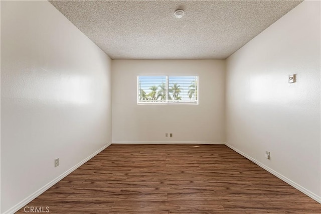 5530 Ackerfield Ave Unit 206, Long Beach, CA 90805 - empty room with a smoke detector, wood finished floors, and a textured ceiling