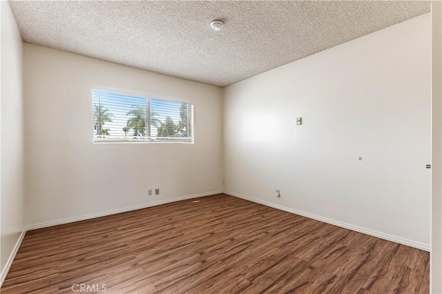 5530 Ackerfield Ave Unit 206, Long Beach, CA 90805 - unfurnished room with wood finished floors, a textured ceiling, and a smoke detector