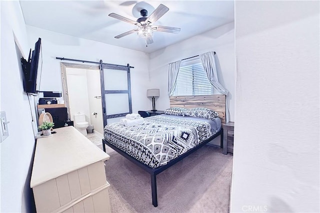 4262 Theresa Ln, Merced, CA 95348 - bedroom with a barn door, a ceiling fan, and carpet