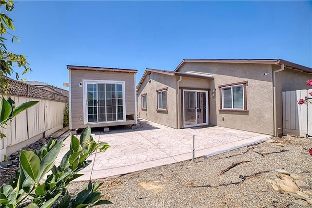 4262 Theresa Ln, Merced, CA 95348 - rear view of house featuring stucco siding, a fenced backyard, and a patio area