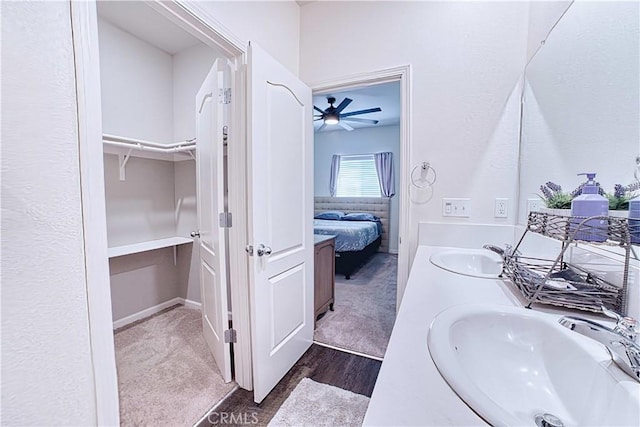 4262 Theresa Ln, Merced, CA 95348 - ensuite bathroom featuring double vanity, a spacious closet, ceiling fan, and wood finished floors