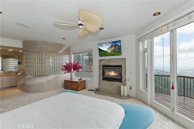 28527 Willow Rd, Lake Arrowhead, CA 92385 - carpeted bedroom with access to exterior, a high end fireplace, ceiling fan, and recessed lighting