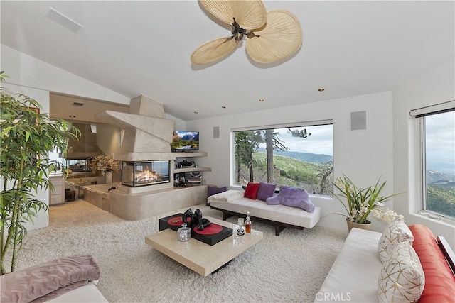 28527 Willow Rd, Lake Arrowhead, CA 92385 - living area featuring healthy amount of natural light, lofted ceiling, a fireplace, a ceiling fan, and carpet