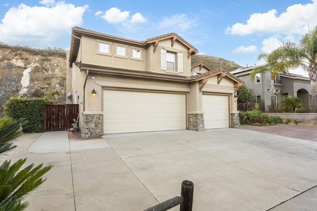 737 W Bel Esprit Cir, San Marcos, CA 92069 - traditional-style home featuring stone siding, driveway, stucco siding, and an attached garage