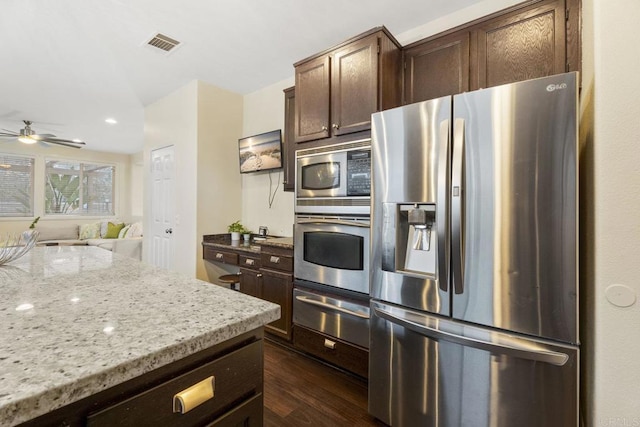 737 W Bel Esprit Cir, San Marcos, CA 92069 - kitchen with stainless steel appliances, a warming drawer, dark wood-style flooring, ceiling fan, and light stone counters